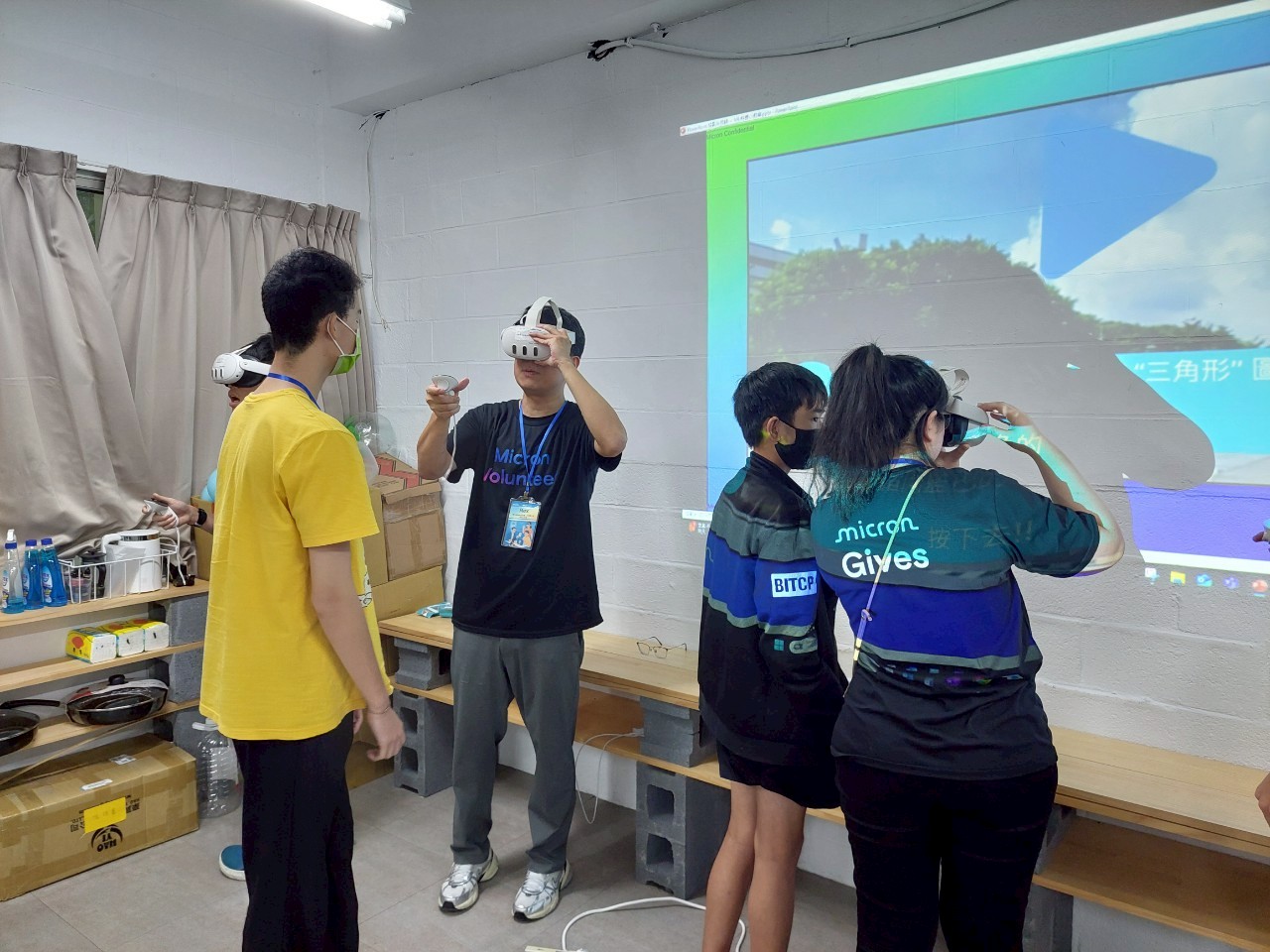 A Micron volunteer guiding a young person through a VR learning activity