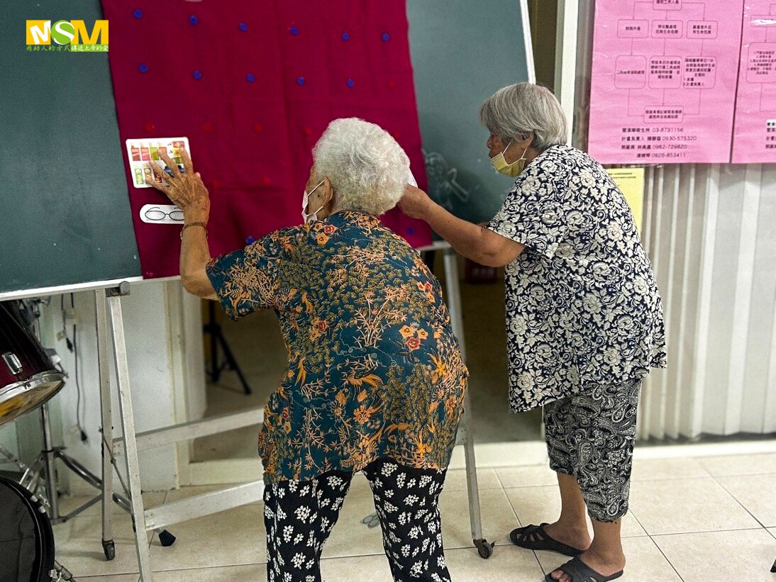 Older residents practicing a hands-on home safety activity in Baliyuan