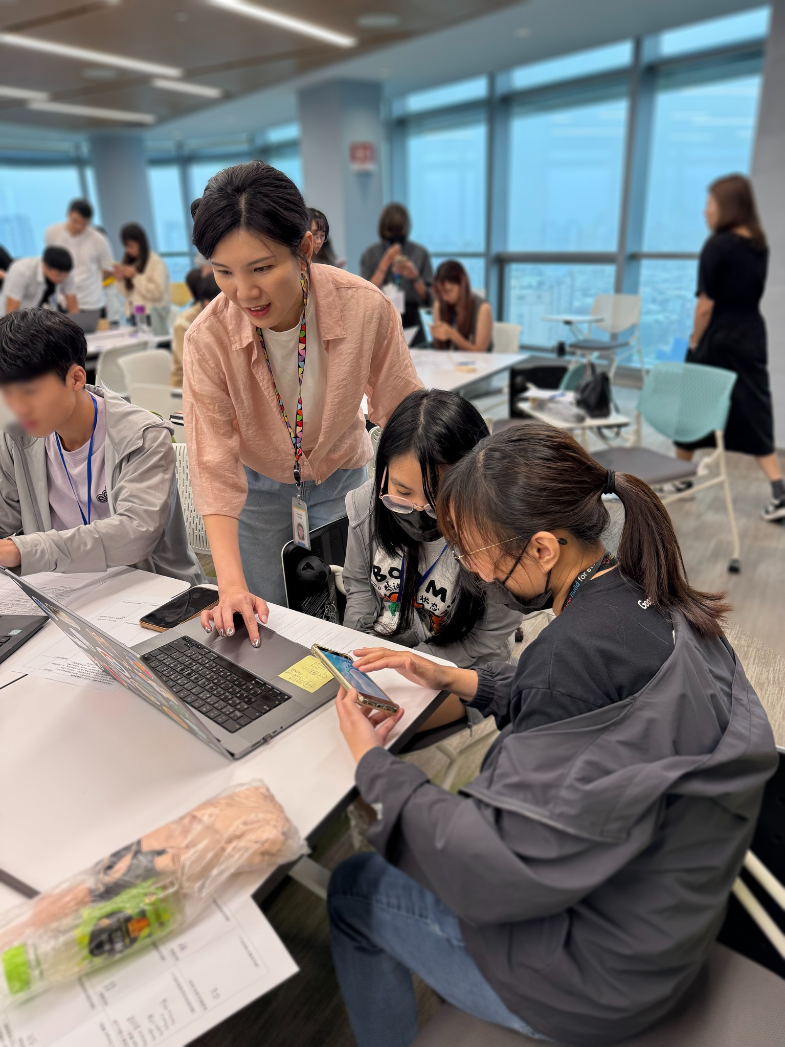 Google employees guiding young people during a technology learning visit
