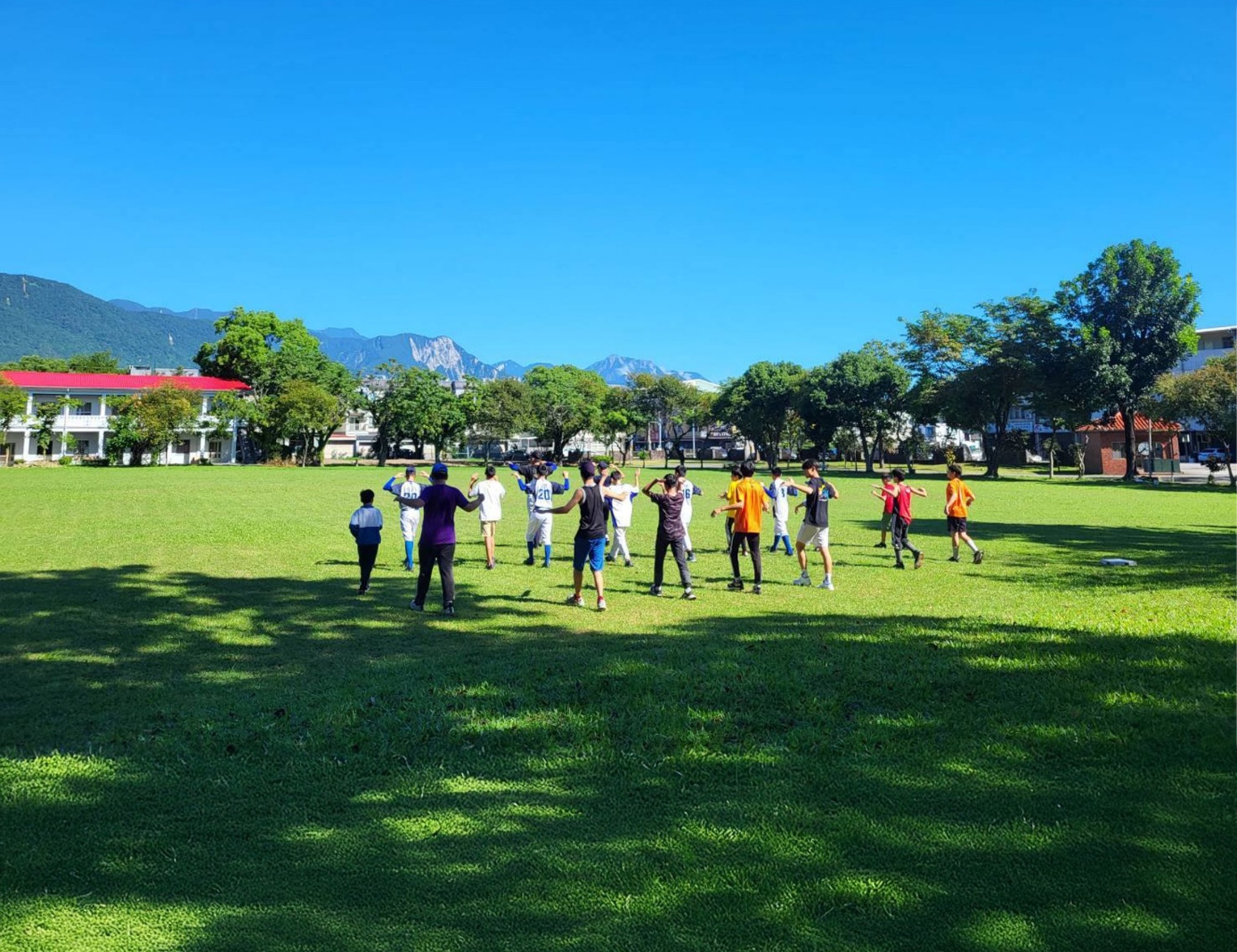 Children and caregivers taking part in an outdoor activity on the lawn at Mustard Seed Youth Home in Hualien