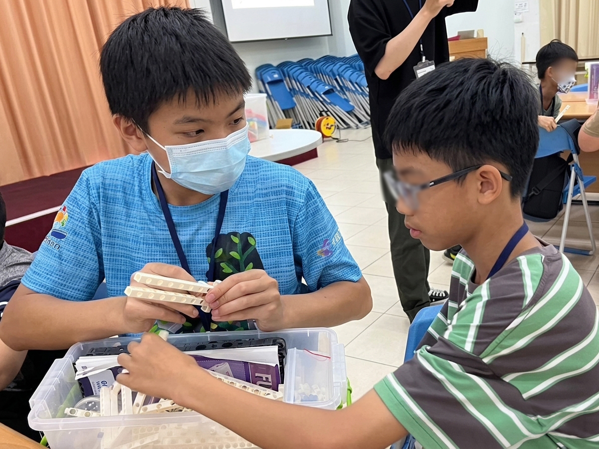 Hua taking part in a hands-on learning activity, with identifying details blurred