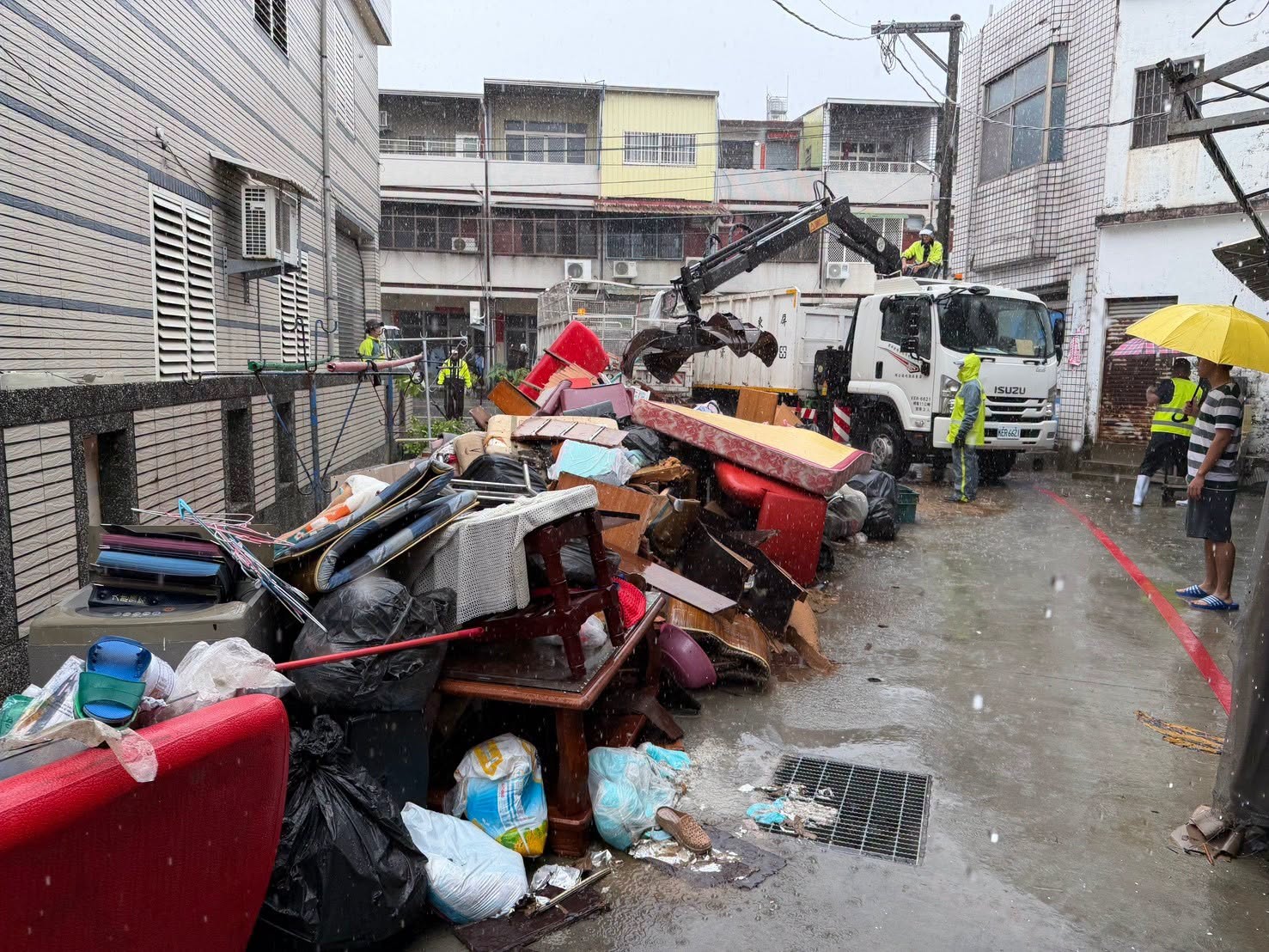 Residents clearing flood debris from their homes after Typhoon Mekkhala