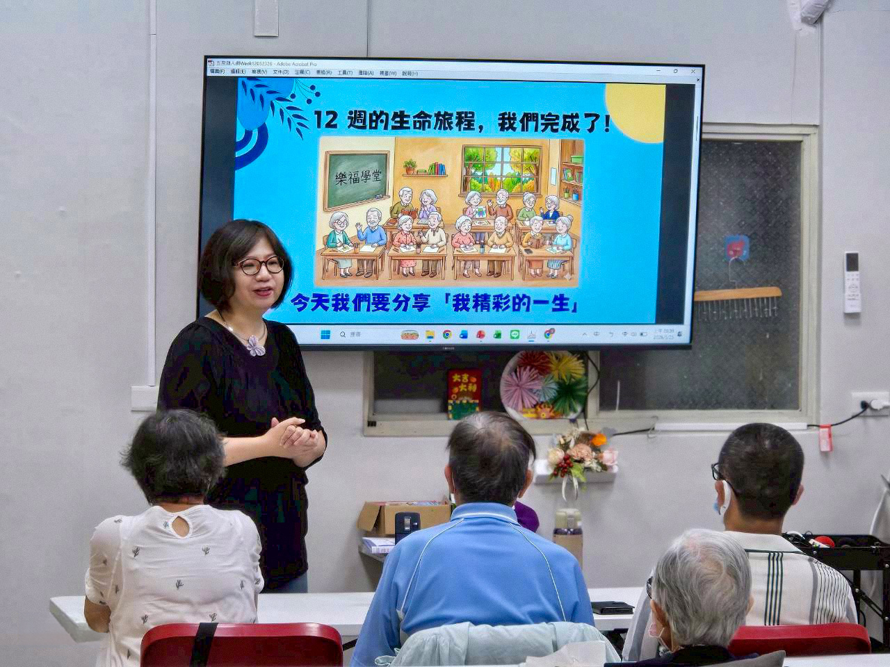 Sisy leading a learning session for older adults in a classroom