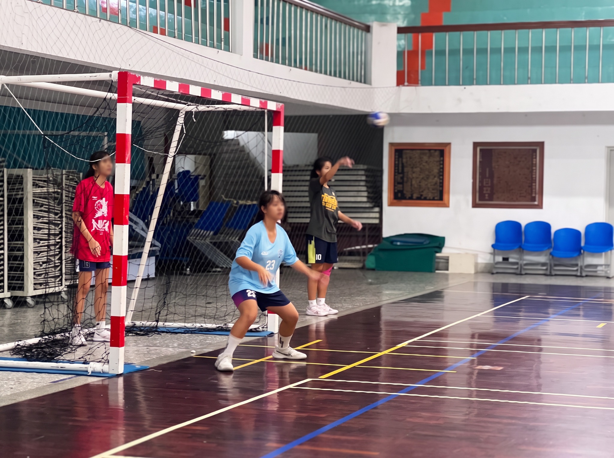 Yuan-Yuan practicing handball; facial features blurred for privacy