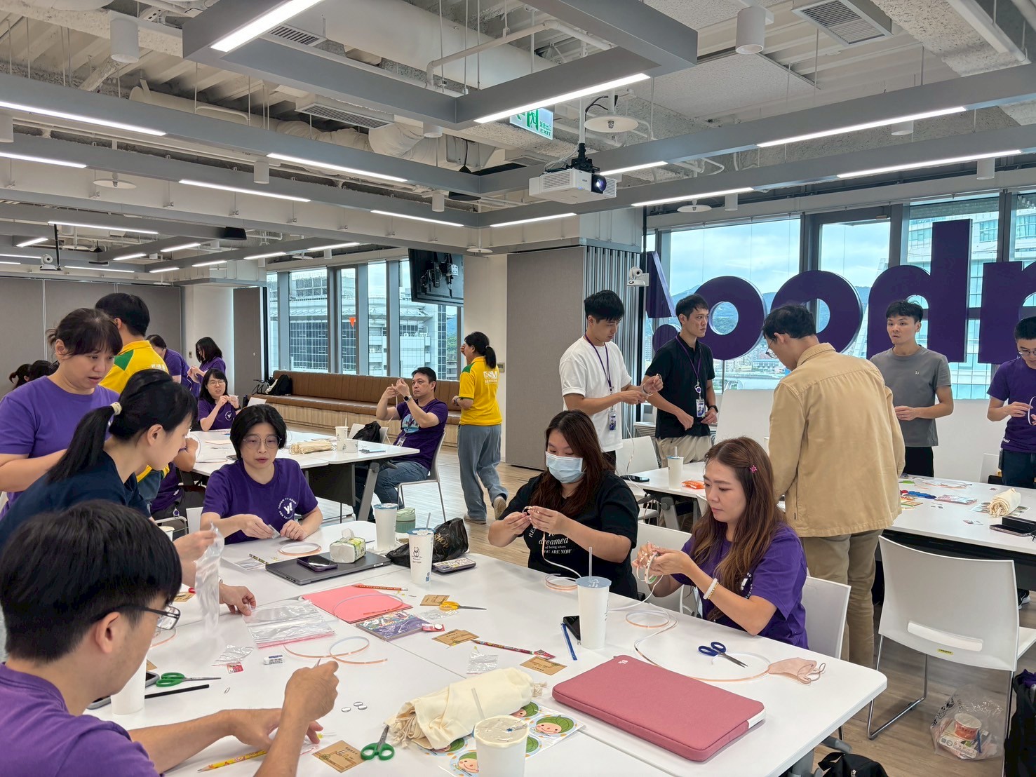 Yahoo volunteers and children participating in a hands-on STEAM activity